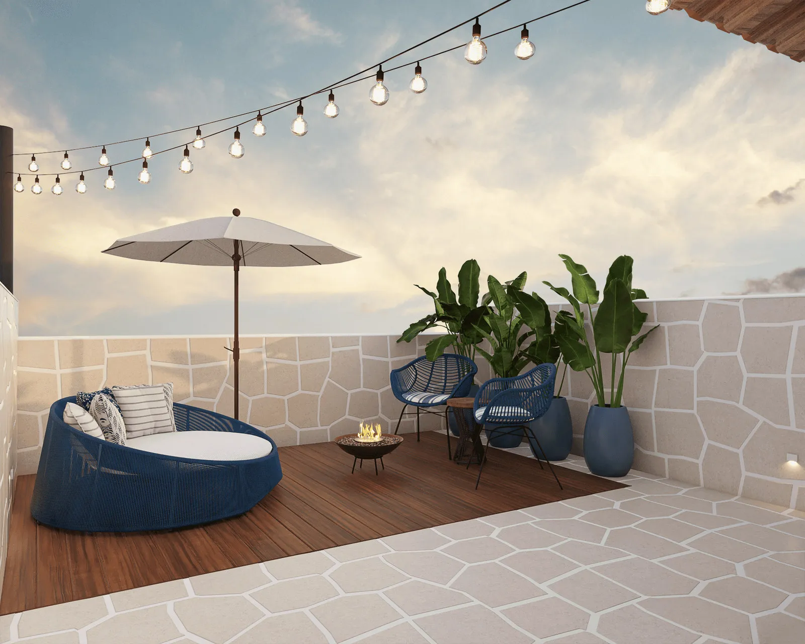 Terraço ao pôr do sol com chaise redonda azul, ombrelone, fogueira, vasos de estrelícia e varal de luzes