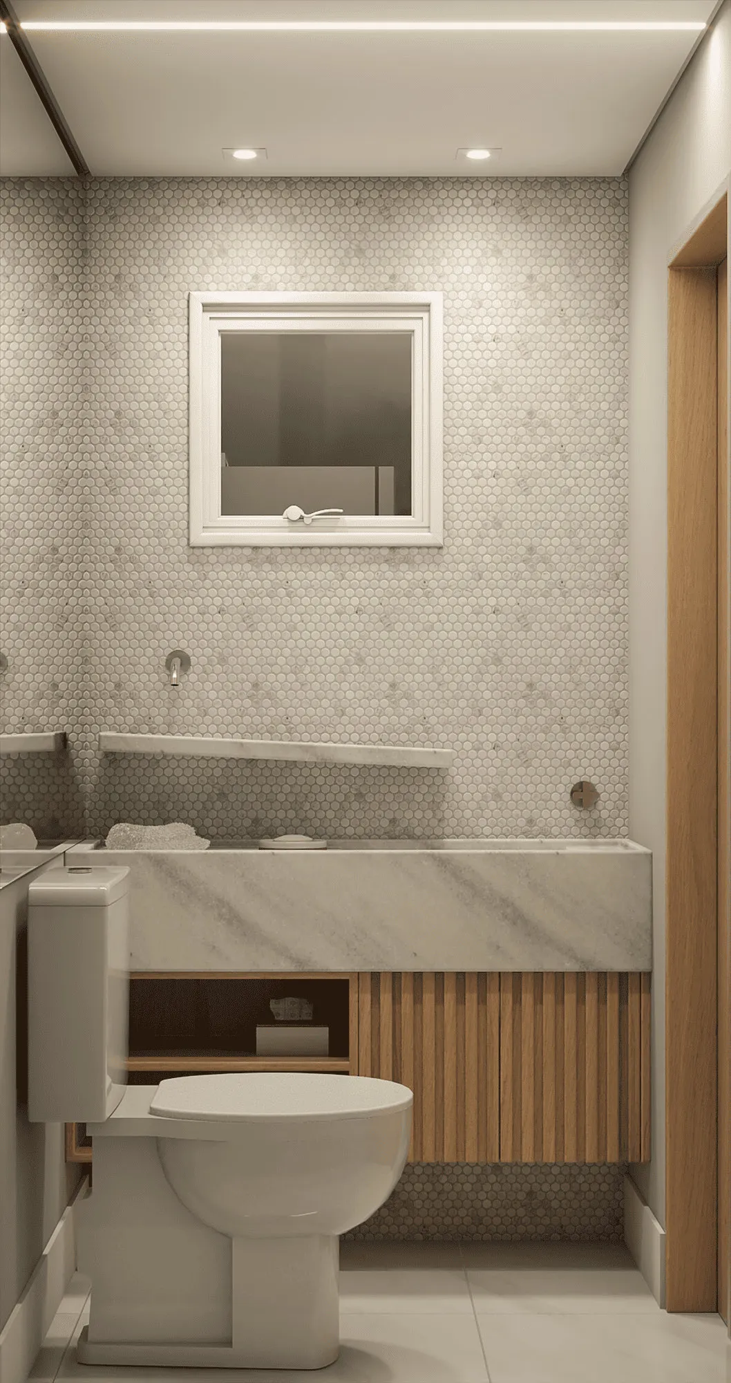 Lavabo com pastilha hexagonal cinza, bancada de mármore, marcenaria ripada de madeira e espelho de moldura branca